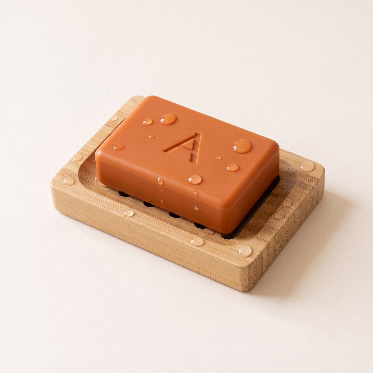 Amevia Persimmon Soap resting on the bamboo soap dish