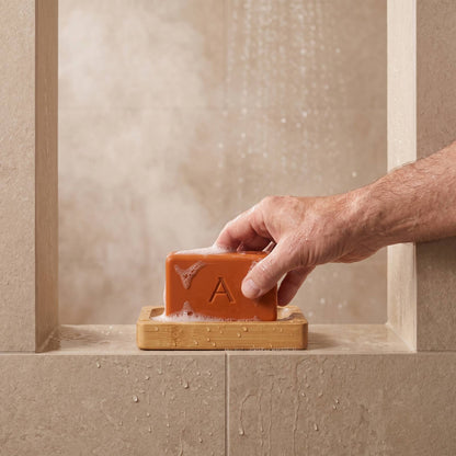Placing Amevia Persimmon Soap back on the bamboo soap dish in the shower